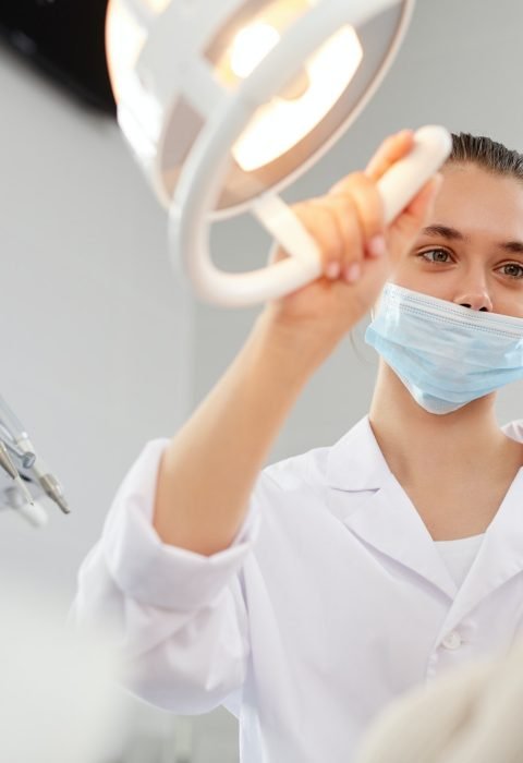 female-dentist-adjusting-lamp.jpg