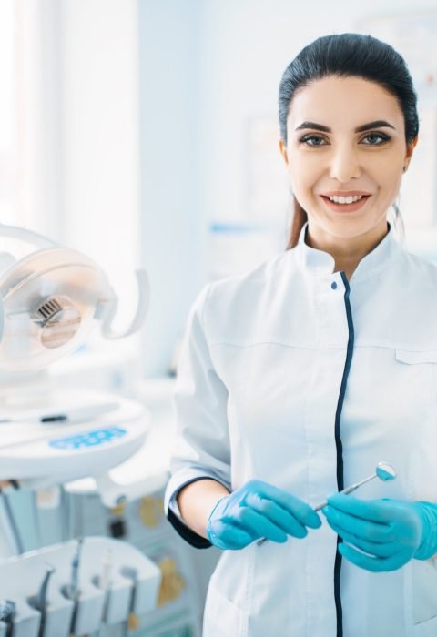 smiling-female-dentist-in-dental-clinic.jpg
